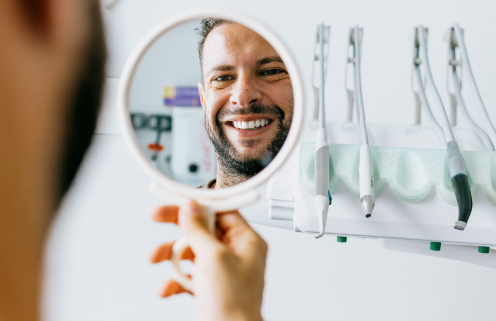 man happy with dental work periodontal treatment concept